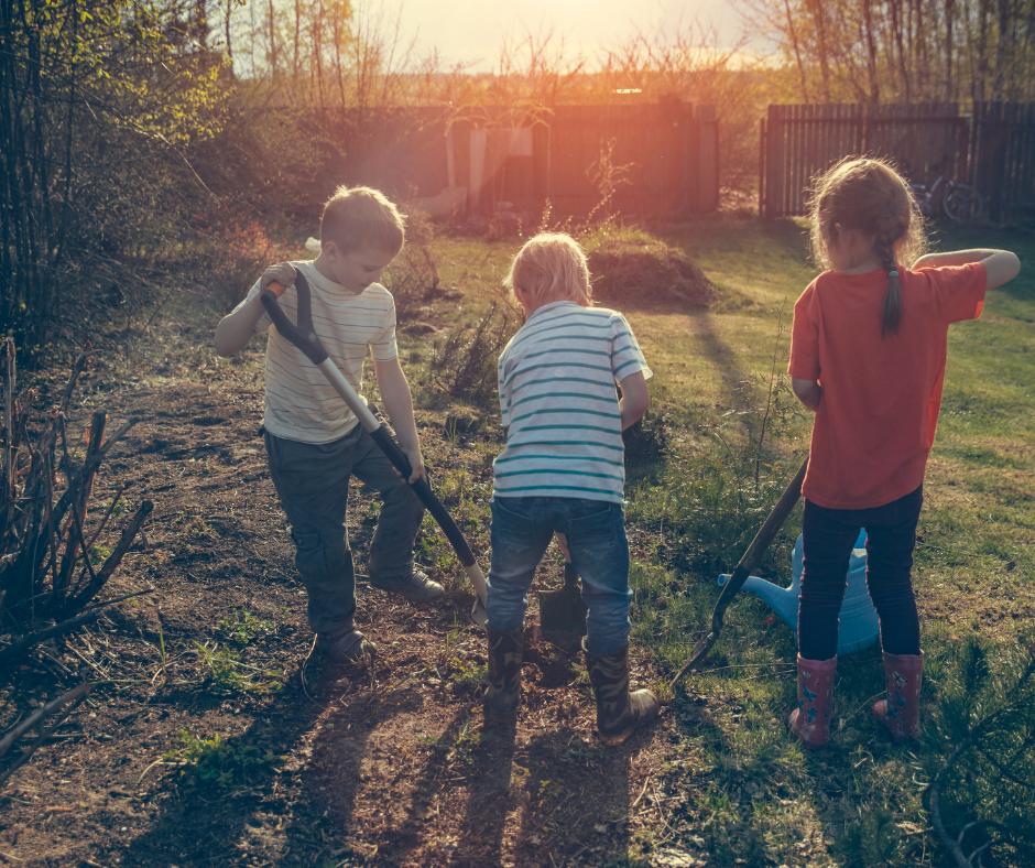 3 children digging in garden